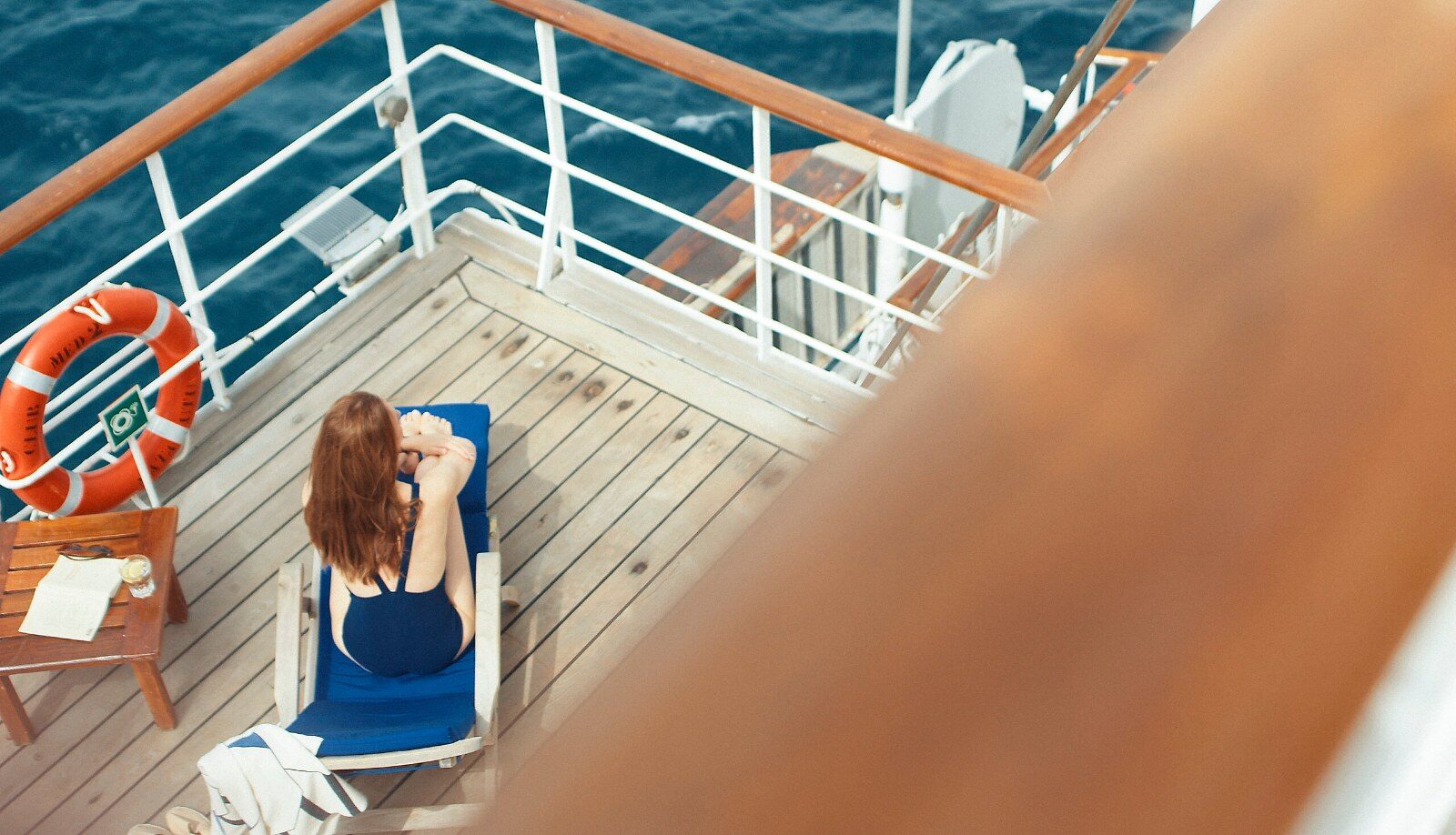 A passenger sunbathing on the foredeck of the Club Med 2