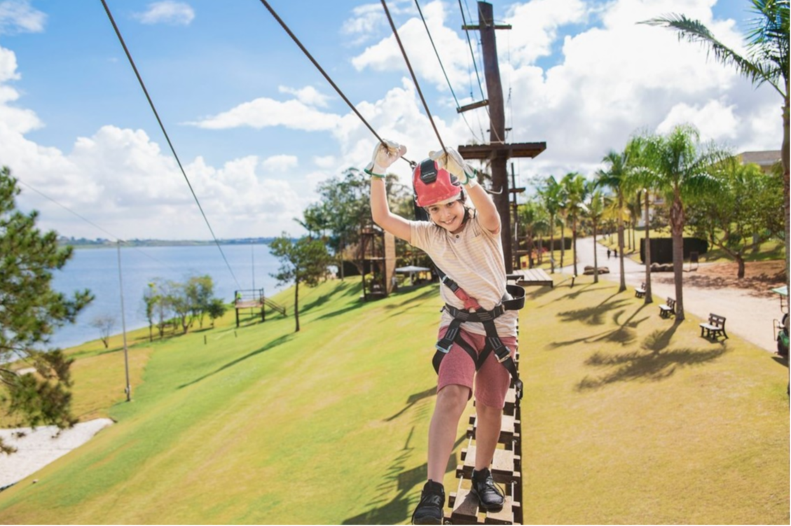 Child on the treetop adventure course at Club Med Lake Paradise, Brazil, enjoying a safe and nature-filled activity.