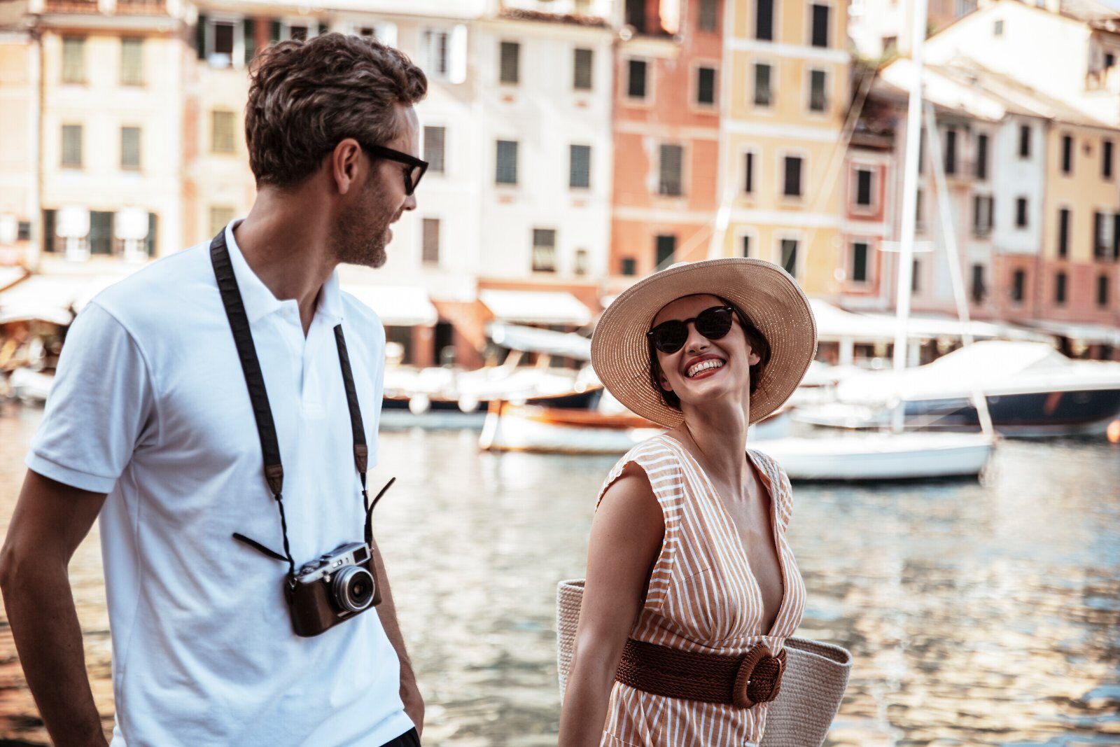 Couple strolling in a colourful harbour on the Italian Riviera