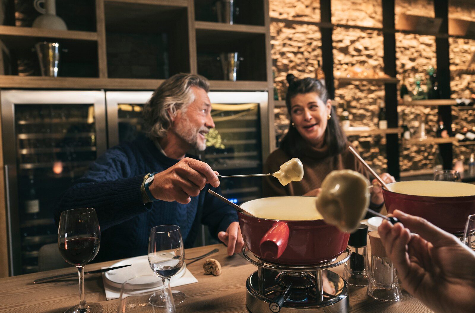 Fondue shared between friends after skiing Fondue shared between friends after skiing