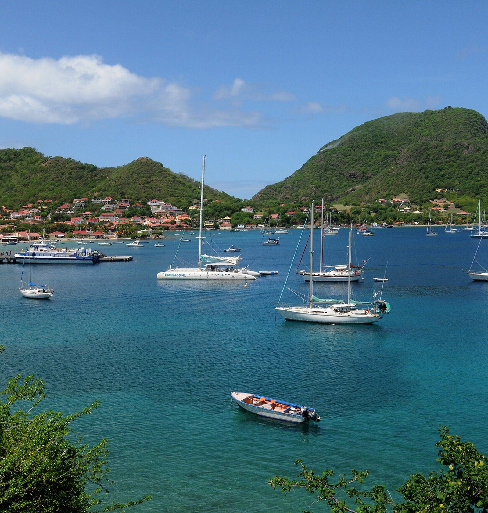 Sailboats anchored in a bay of the Antilles