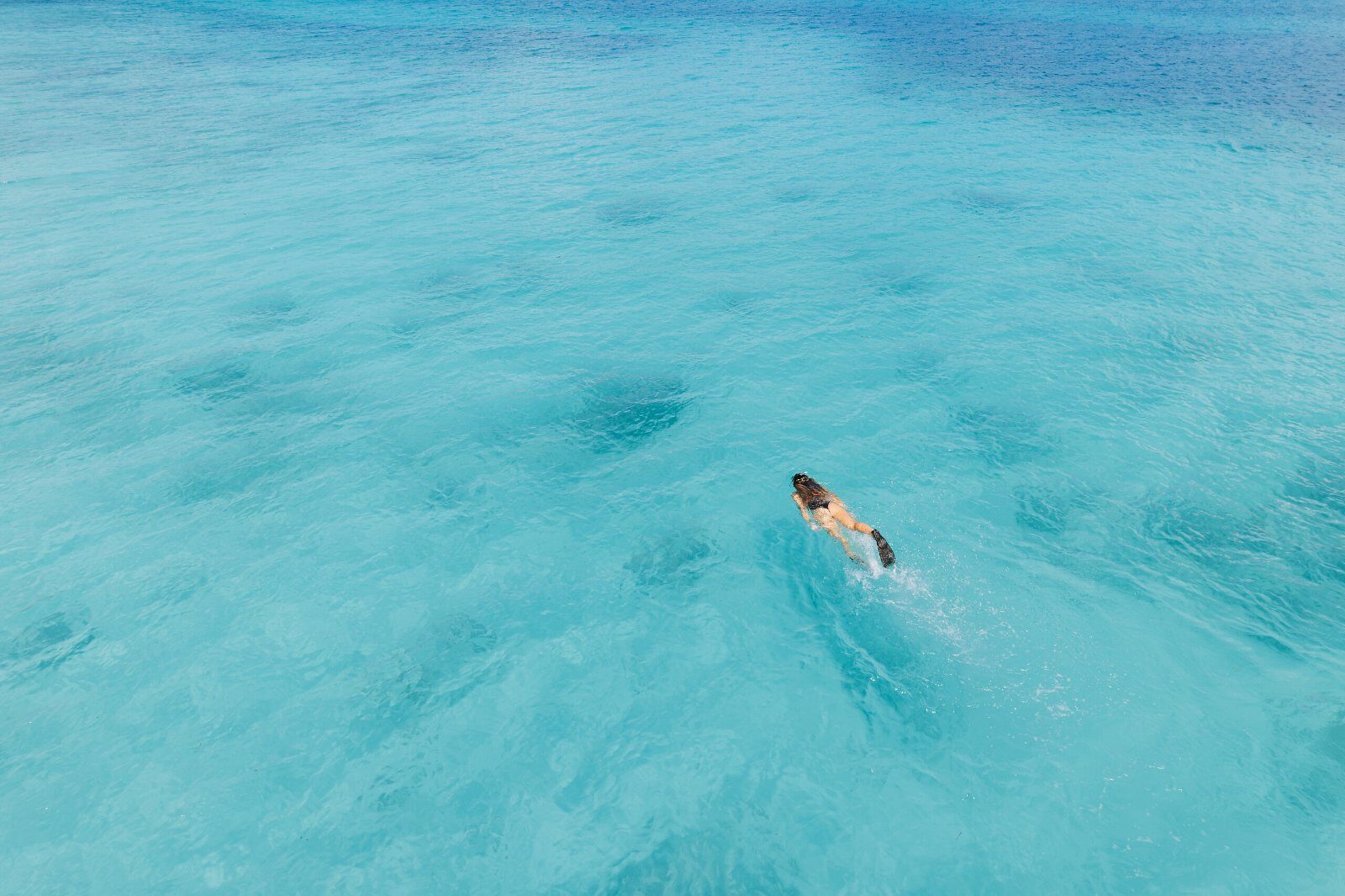 Swimmer in the clear water of the Seychelles