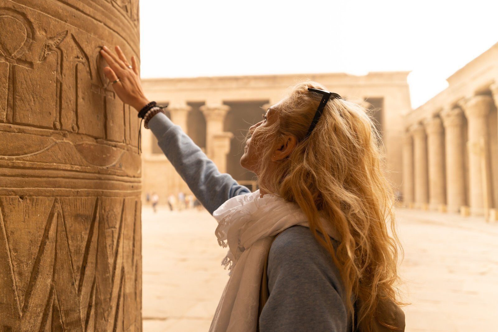 Traveller by the carved columns of an Egyptian temple