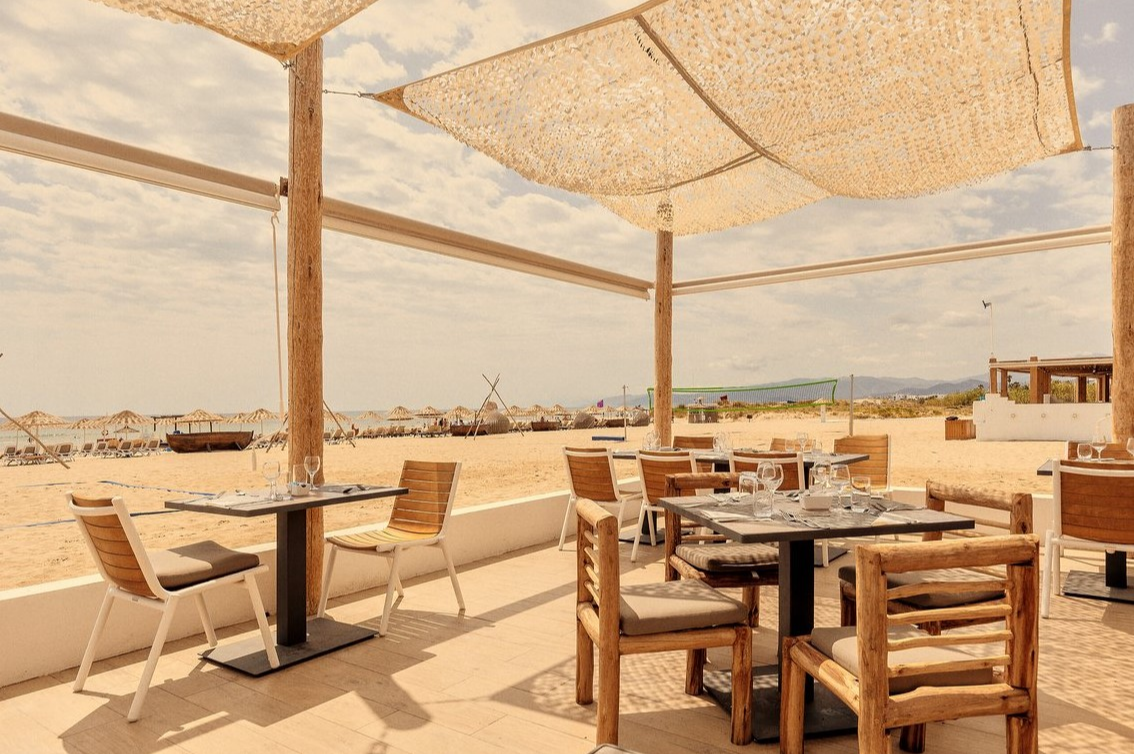 Terrace of the Gibraltar restaurant at Club Med Yasmina, located on the beach, featuring a chic bohemian ambiance and sea views.