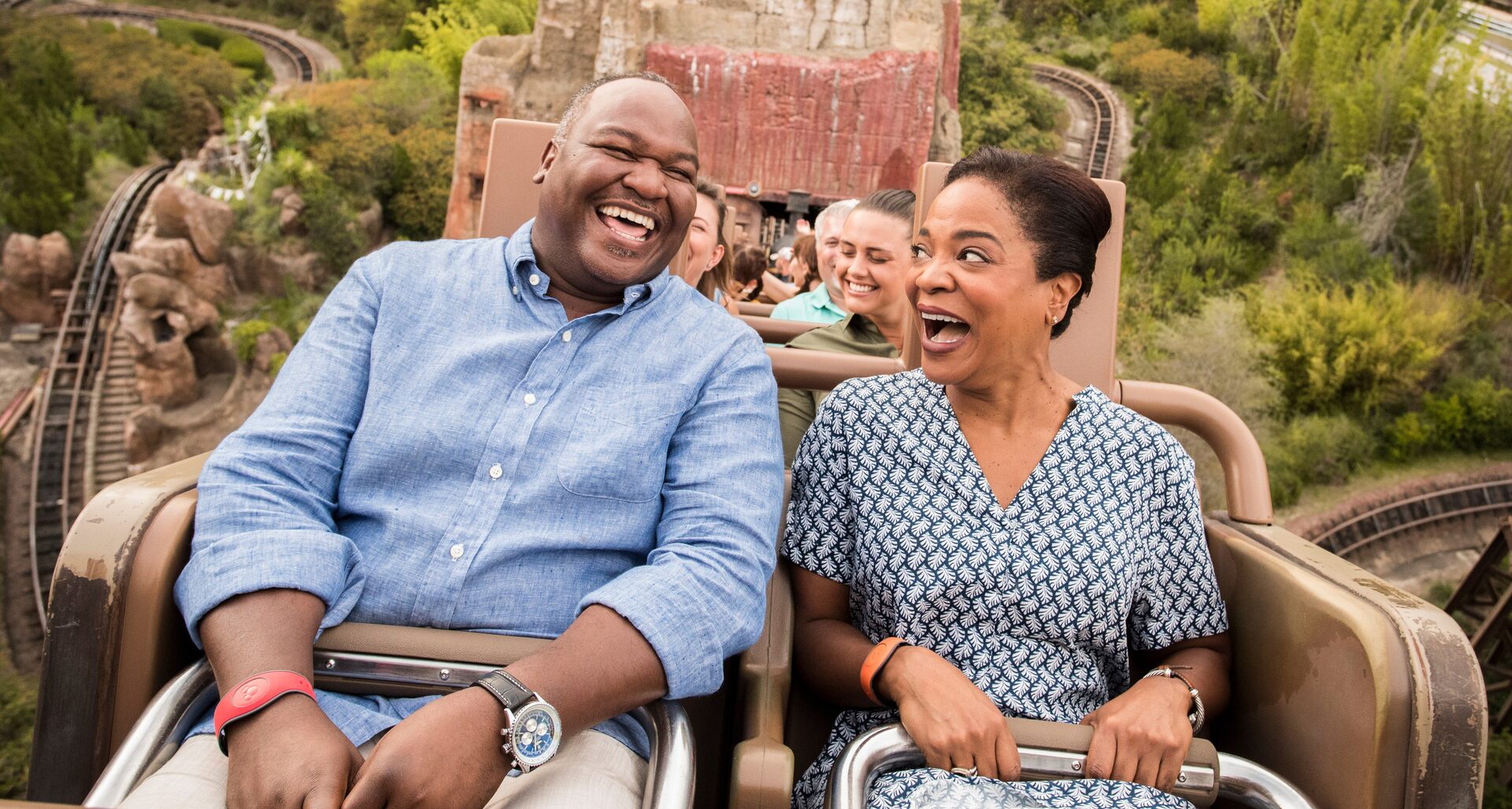 A couple laughs in the Expedition Everest ride car, the rocky mountain behind them, at Disney’s Animal Kingdom A couple laughs in the Expedition Everest ride car, the rocky mountain behind them, at Disney’s Animal Kingdom