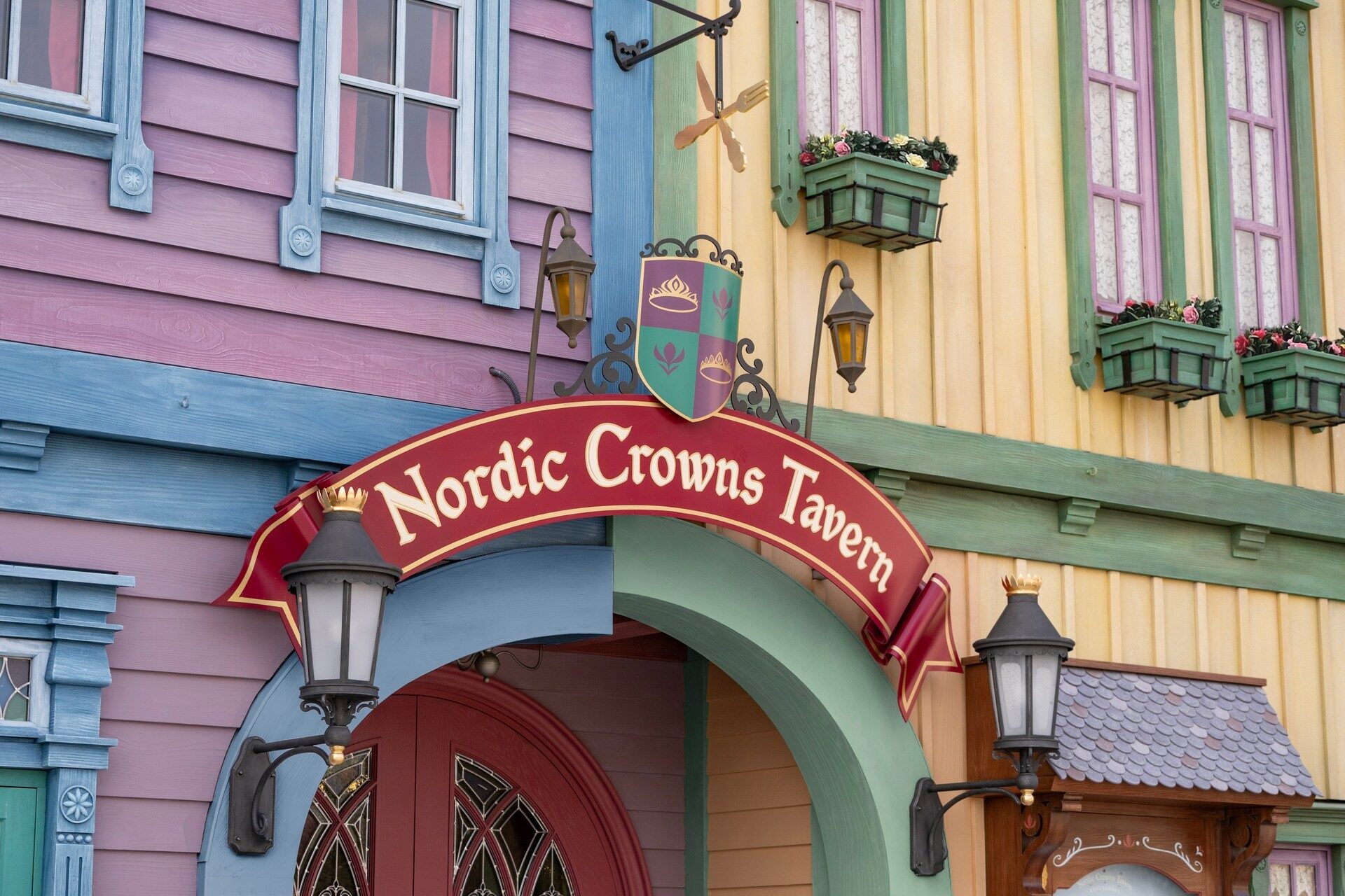 The Nordic Crowns Tavern sign in the village of Arendelle at World of Frozen, among colourful facades with flower boxes. Photo: ©Disney. The Nordic Crowns Tavern sign in the village of Arendelle at World of Frozen, among colourful facades with flower boxes. Photo: ©Disney.