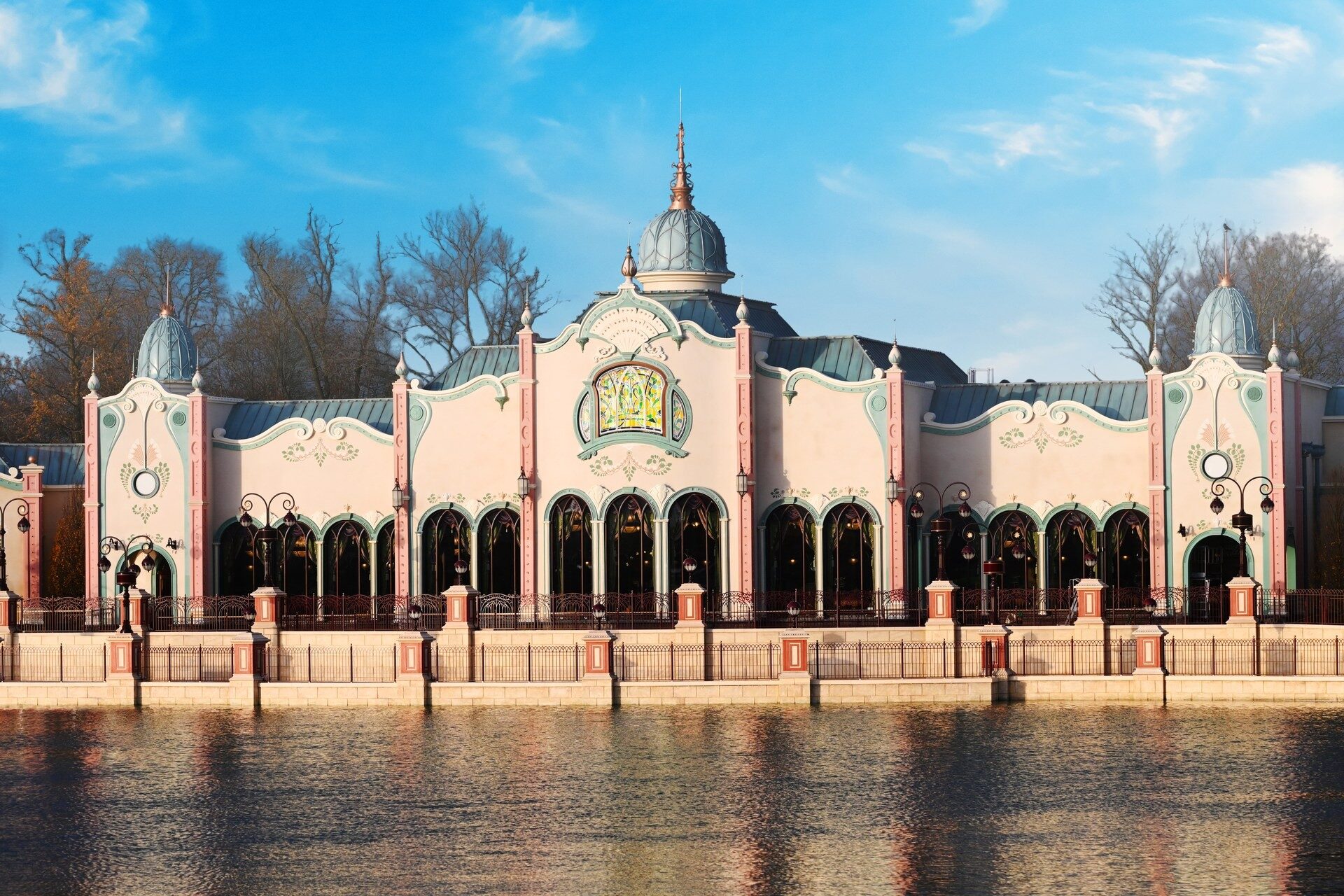 The Regal View Restaurant & Lounge at Disney Adventure World, a large pink and white pavilion on the shore of Adventure Bay. Photo: ©Disney. The Regal View Restaurant & Lounge at Disney Adventure World, a large pink and white pavilion on the shore of Adventure Bay. Photo: ©Disney.