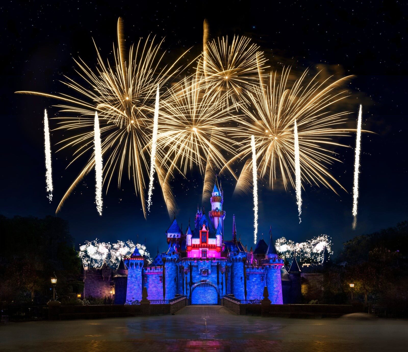 Sleeping Beauty Castle lit up beneath the fireworks at Disneyland Park in California
