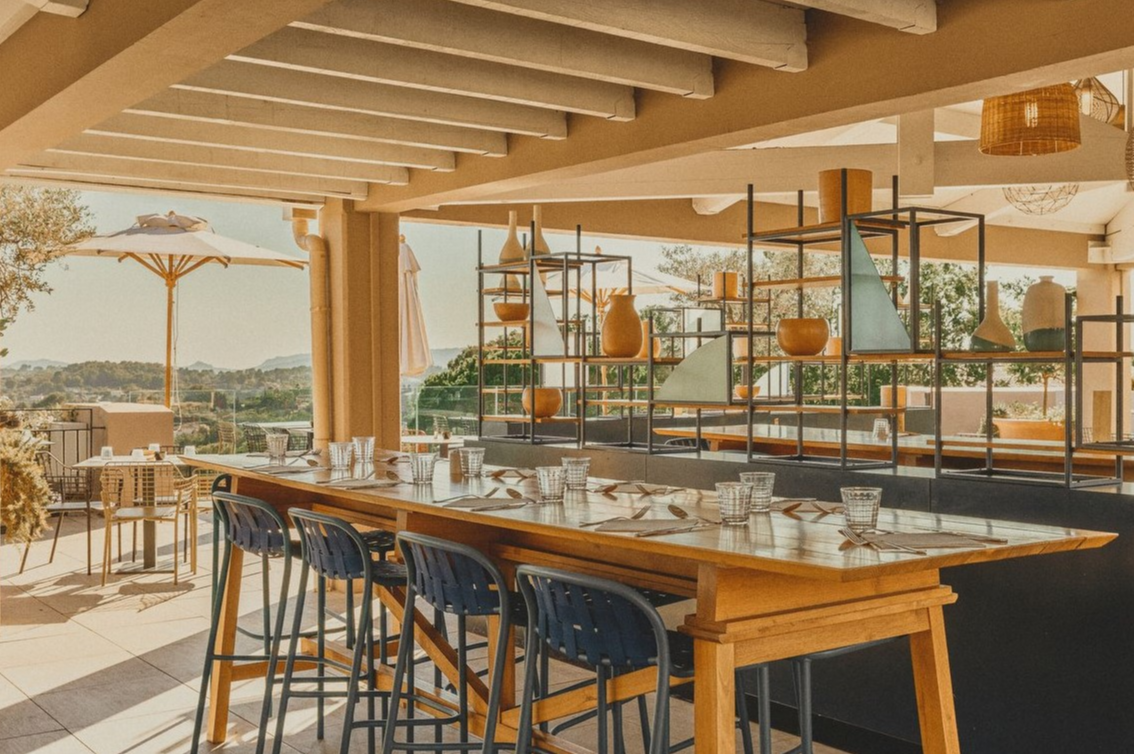 Bistro-style table on the panoramic terrace of La Provence restaurant at Club Med Opio in Provence, perfect for dining together.