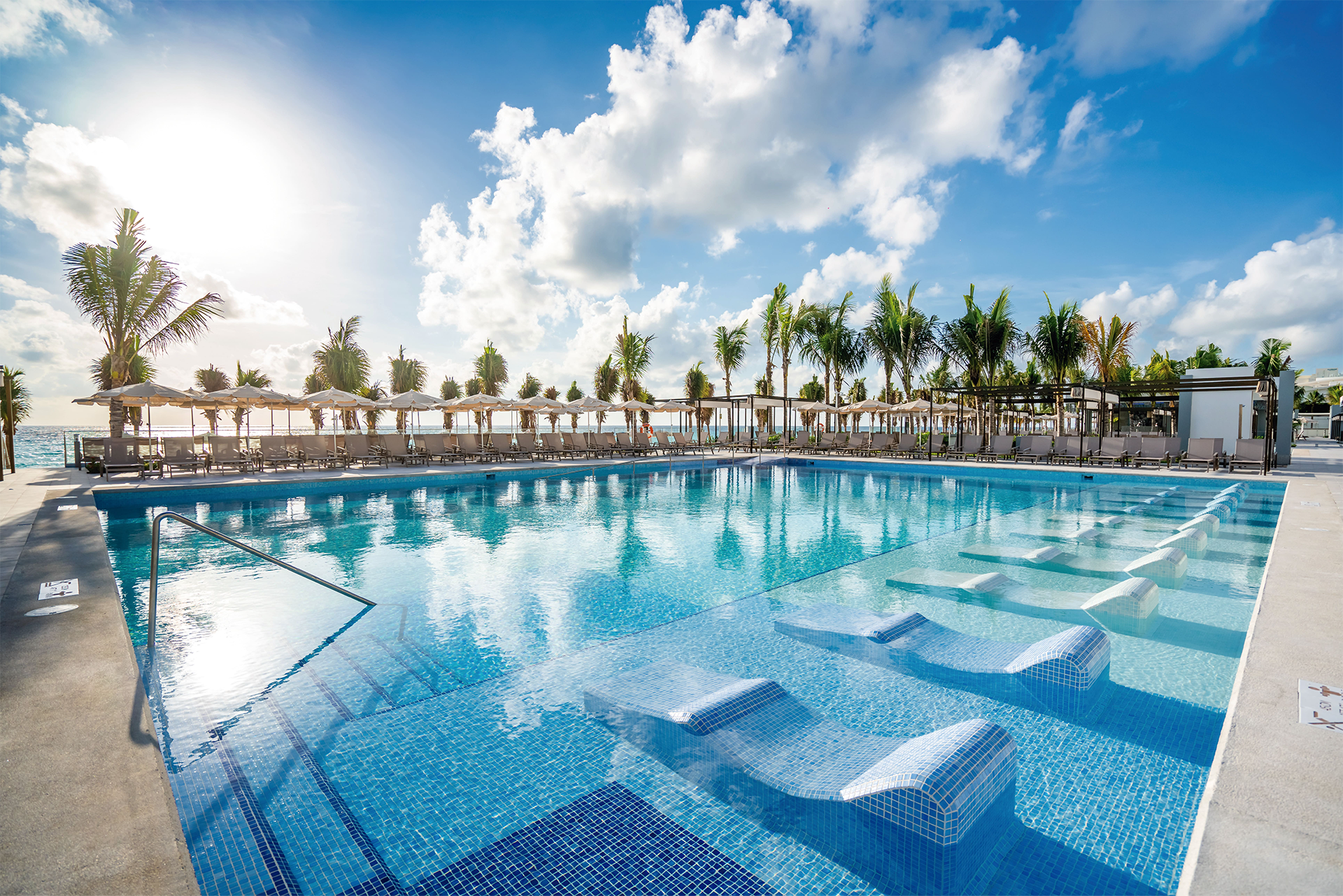 Riu Palace Kukulkan Cancun Hotel Zone Mexico Kukulkan Boulevard pool with palm trees and sea views