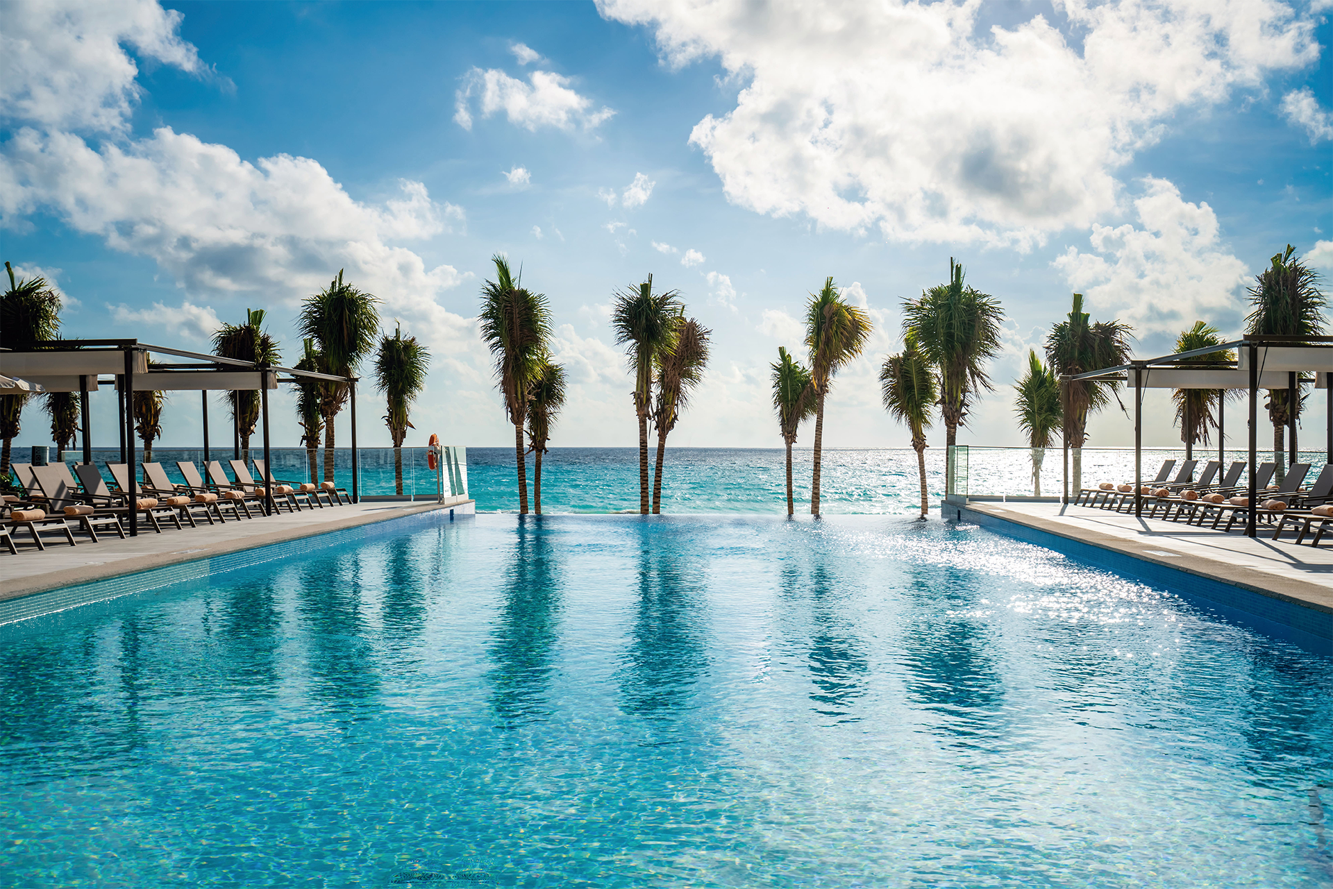 Riu Palace Kukulkan Cancun Hotel Zone Mexico Kukulkan Boulevard infinity pool with palm trees and sea views