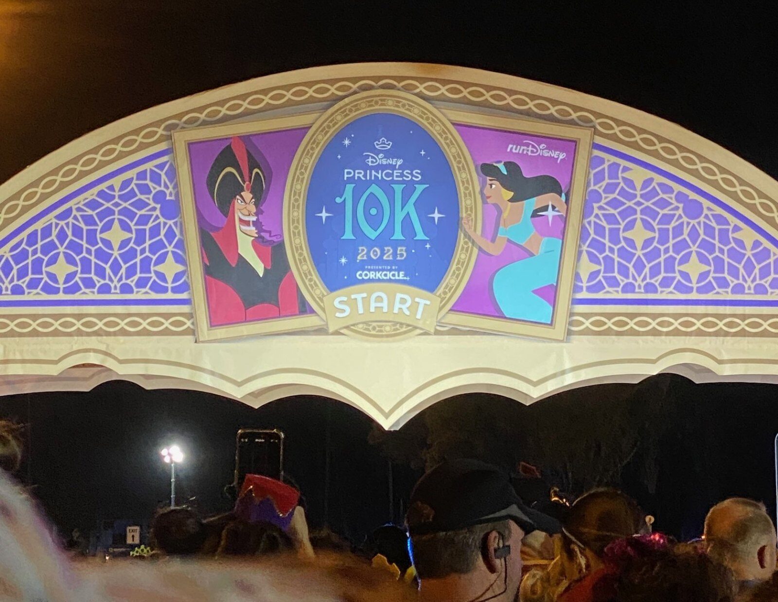 Disney Princess 10K start arch before dawn, runners gathered in the corrals Disney Princess 10K start arch before dawn, runners gathered in the corrals