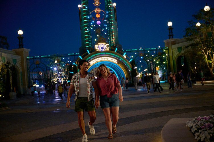 Guests walking under the Universal Epic Universe archway