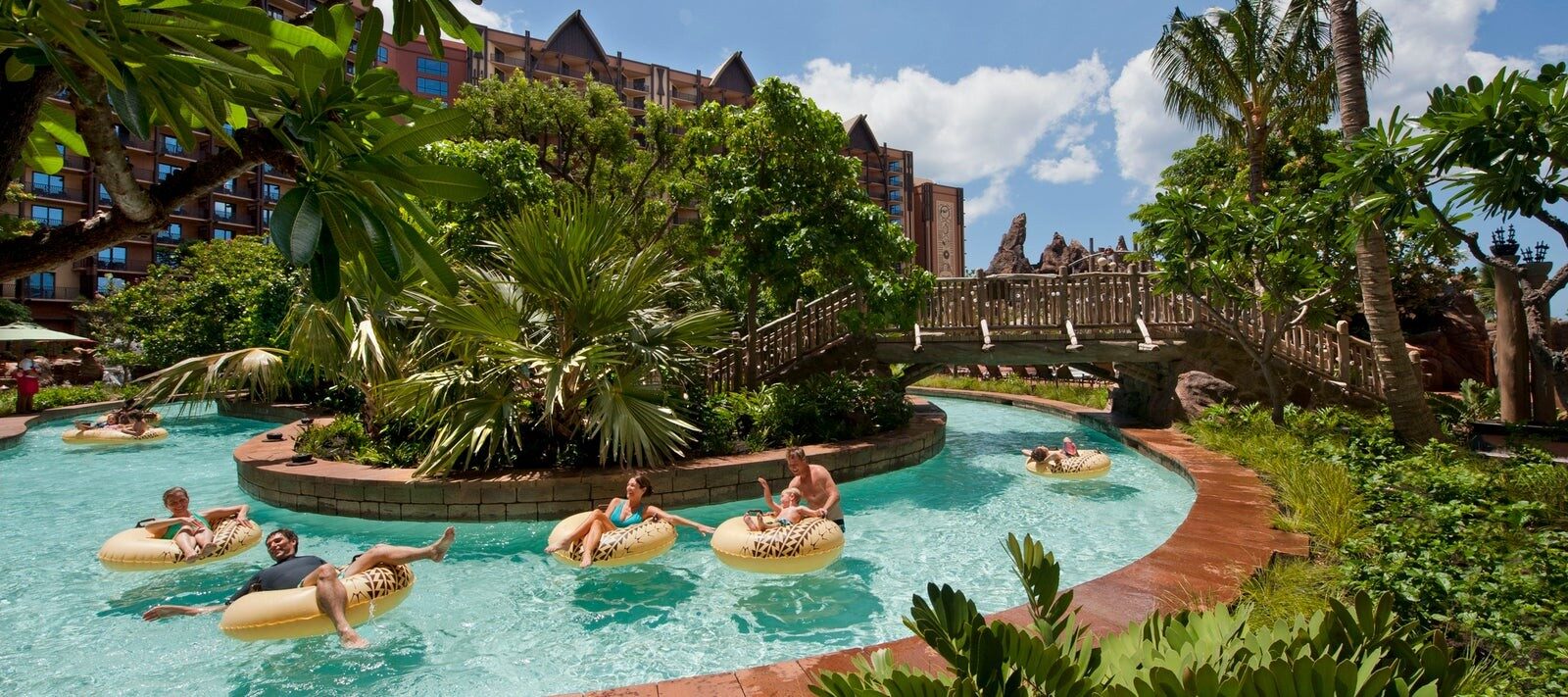 Swimmers drifting on inner tubes along the Waikolohe Stream at Aulani